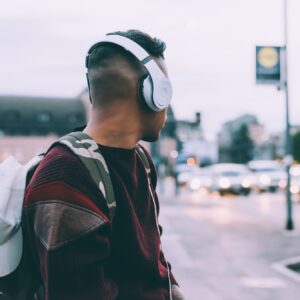 back view young man listening music