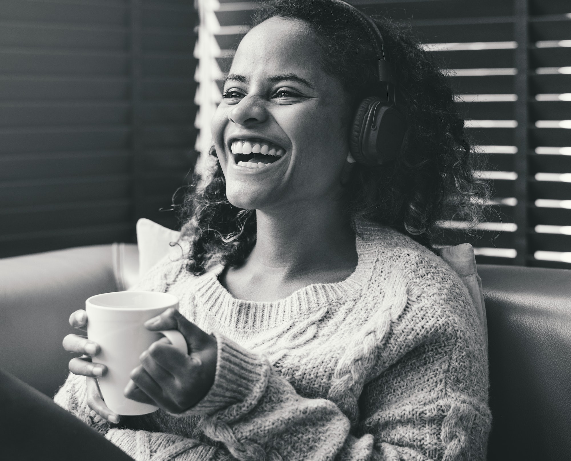 Woman enjoying music on the sofa
