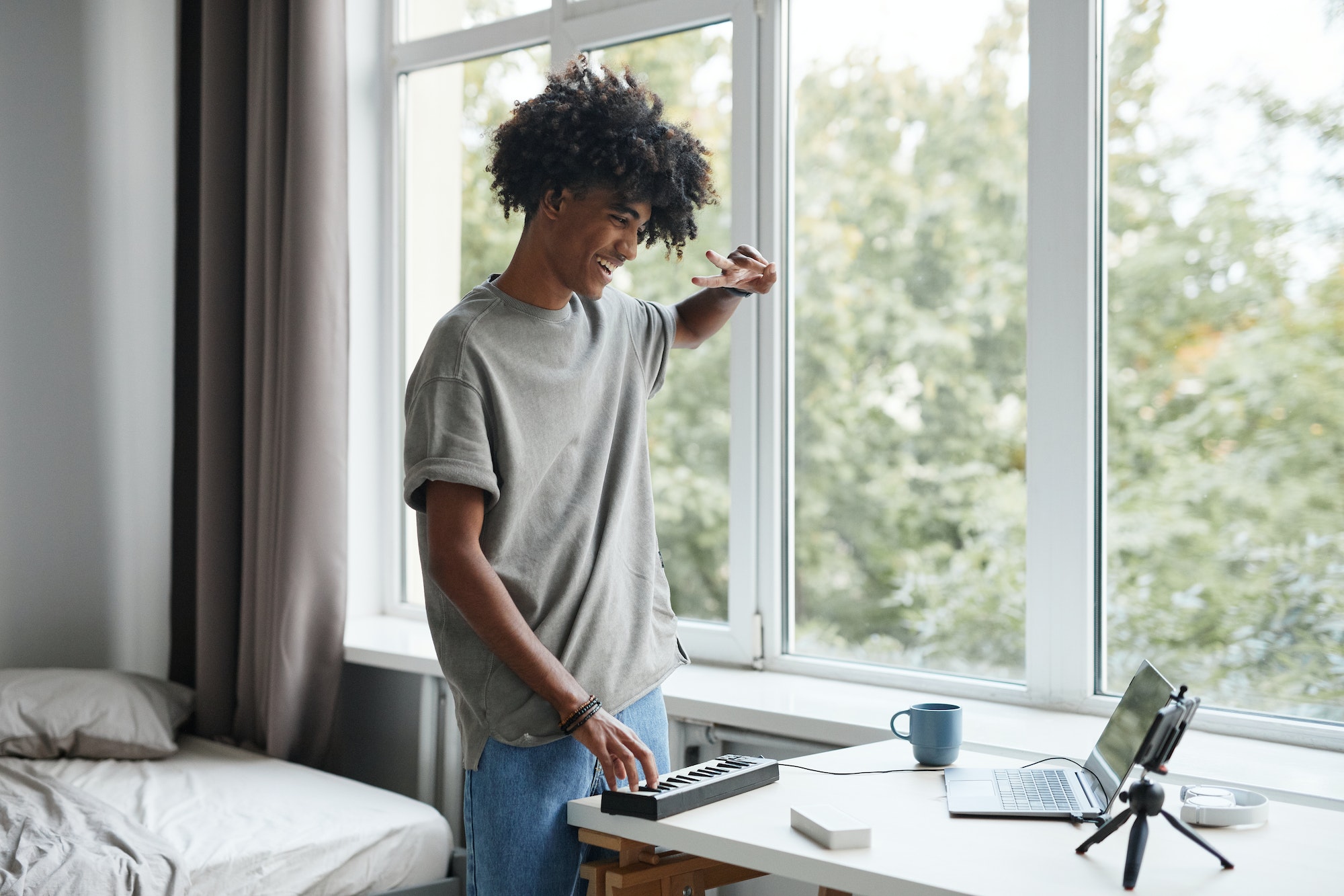 Young Man Recording Music at Home